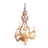 NINETEENTH-CENTURY ROCOCCO GILT BRONZE CHANDELIER of eight asymmetrical arms, suspended on four