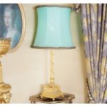 CARVED GILTWOOD TABLE LAMP AND SHADE the reeded stem with entwined leaf decoration raised on a