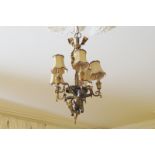 EDWARDIAN PERIOD GILT BRONZE CHANDELIER with a ribbon suspended cherub, supporting five scroll