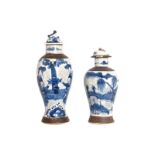 TWO CHINESE QING PERIOD BLUE AND WHITE CRACKLE GLAZE URNS AND COVERS each with figural decoration