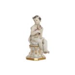LATE EIGHTEENTH-CENTURY/ EARLY NINETEENTH-CENTURY PORCELAIN FIGURE OF A CHERUB HOLDING A SICKLE