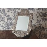 SILVER FRAMED VANITY MIRROR with rich embossed decoration depicting cherubs, London 1858, Maker