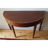 GEORGE III FOLD-OVER TEA TABLE the demi-lune shaped cross banded top, opening to a polished