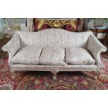 IRISH EDWARDIAN PERIOD MAHOGANY AND UPHOLSTERED GAINSBOROUGH HUMP-BACK SETTEE raised on scallop