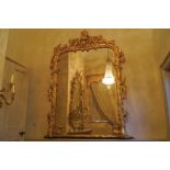 LARGE NINETEENTH-CENTURY CARVED GILTWOOD OVER MANTEL MIRROR the rectangular plate, the head with