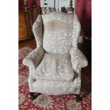 EDWARDIAN PERIOD MAHOGANY AND UPHOLSTERED WINGBACK ARMCHAIR with loose feather and down cushion,