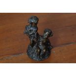 NINETEENTH-CENTURY FRENCH BRONZE GROUP OF CHERUBS one holding flowers, the other holding a sheaf