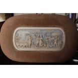 NINETEENTH-CENTURY CARVED IVORY PANEL depicting figures coming home from the field, enclosed in a