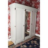 ARTS & CRAFTS PAINTED PINE WARDROBE the moulded crown above a central mirror door, flanked by a