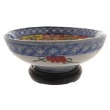Chinese Qing period  blue and white bowl with polychrome decoration, raised on a hardwood base