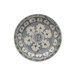 Chinese Qing period blue and white plate with faceted central flower, surrounded by multiple