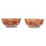 Pair of russet glazed bowls each with Phoenix and dragon decoration, seal mark on the underside