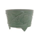 Chinese celadon jardinière of circular waisted form with a moulded body, raised on scroll feet