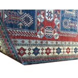 Handmade Kazakh carpet Caucasus region of Azerbaijan, with ivory border and two rectangular blue