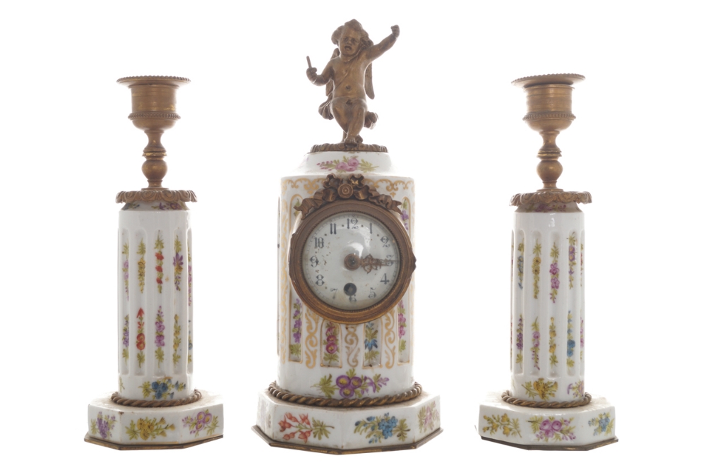 Nineteenth-century porcelain and ormolu mounted clock garniture Comprising: a cherub mounted