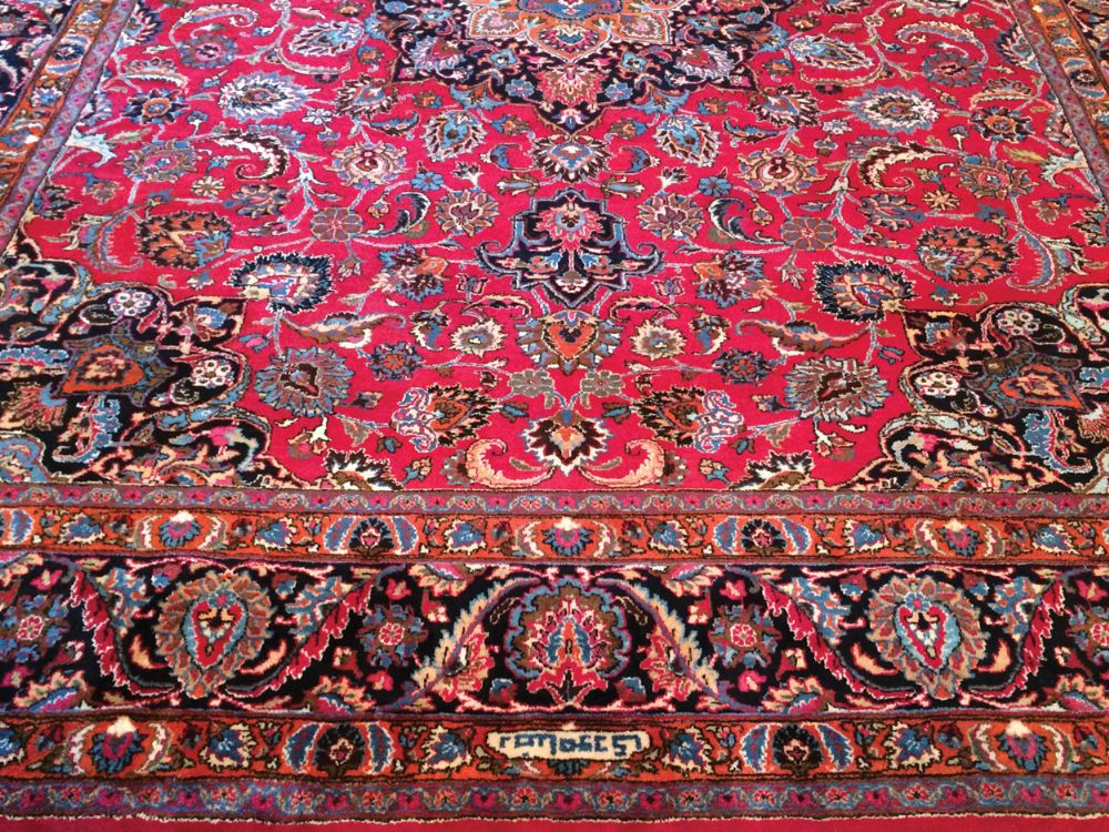 Handmade North East Persian carpet fine carpet weaving, including weaver's signature, on rich red