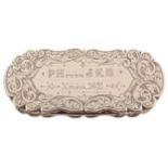 Nineteenth-century silver snuff box of oval serpentine shape, with ornate leaf scroll decoration,