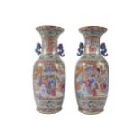 Pair of large Chinese Qing period famille rose vases each depicting figures in multiple panels, with