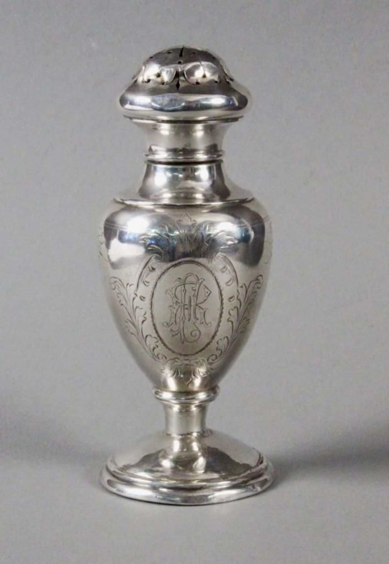 A SALT SHAKER Vienna, ca. 1900 Silver, baluster form with engraved decor and ligate monogram,