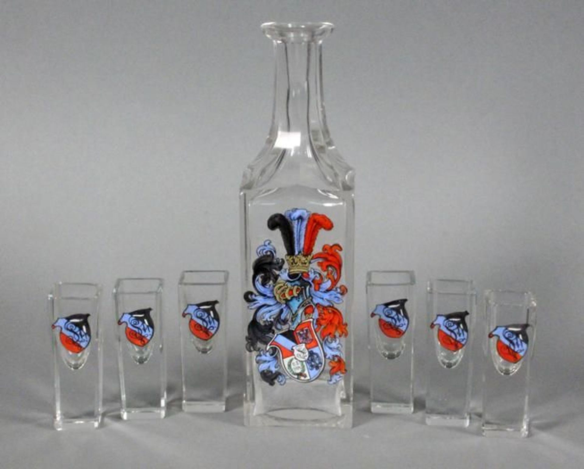 A STUDENT BRANDY SERVICE Glass decanter with 6 liqour glasses, coloured students' coat of arms,