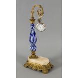 Opening: 190 EUR    A POCKET WATCH STAND 19th century Gilt bronze base with marble plate, on top
