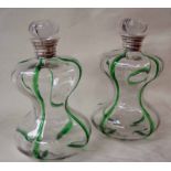 A pair of late Victorian clear glass Decanters of blown waisted hour glass form with green trailed