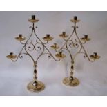 A good quality pair of late 19th century wrought brass five branch Candle Stands of triangular