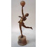 An Art Deco bronze patinated spelter figural model of a female dancer in typical costume, holding