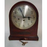 An Edwardian mahogany and inlaid cased Mantel Clock of arch top form set on shallow bun feet, the