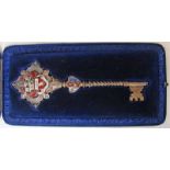 A Victorian gilt and enamel presentation key by Elkington and Co, dated 1891, inscribed for