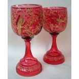 A pair of late 19th/early 20th century cranberry glass goblets of typical form, U shape bowl on