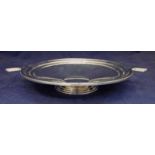 An Art Deco silver comport of stepped circular form with stylised handles set on a stepped spreading