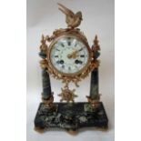 A French 19th century Portico Clock, green marble and ormolu with cast bird on a branch set on top