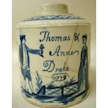 A late 18th century cream ware pottery canister of cylindrical form, decorated in underglaze blue