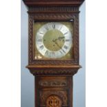 A good quality reproduction oak longcase clock, the brass and silvered 33cm dial with spandrels,