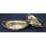 A pair of George VI silver sweetmeat dishes of oval shape with shaped everted rim upturned at either