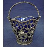 A late 18th century, George III silver swing handle sugar basket, cast as a bucket shape with