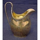 An early 20th century silver milk jug of helmet form, ribbed rim and loop handle, Chester 1904, 3.