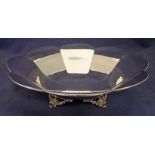 A 1930's English silver fruit bowl of octagonal flower head form set on four cast acanthus feet,