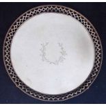 An Edwardian silver salver of circular form with pierced and beaded upturned rim, centrally engraved