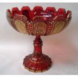 A late 19th century Bohemian ruby glass pedestal bowl, the circular bowl with castellated rim on a