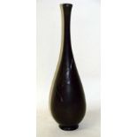 A Japanese bronze bottle vase of slender circular form with elongated neck, decorated in bas