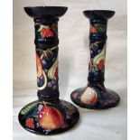 A pair of Moorcroft pottery candlesticks, tubeline decorated in the Queen's Choice design by Sian