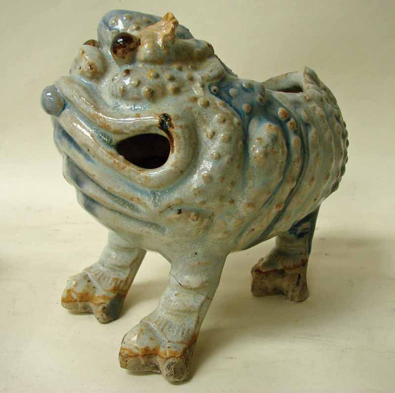 A Chinese glazed stoneware vase or spoon warmer in the form of a grotesque three legged toad, mottle