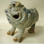 A Chinese glazed stoneware vase or spoon warmer in the form of a grotesque three legged toad, mottle
