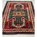 A Caucasian wool rug, circa 1970, handmade, geometric motifs in a double border, 1199cm by 149cm,