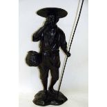 A Japanese ebonised bronze model of a Bird Catcher standing holding a cane and line, carrying a