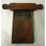 A 19th century mahogany and brass mounted pill roller with double handle pill roller and
