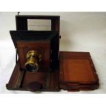 A Victorian mahogany Field Plate Camera, bellows action with unnamed lens and three double plate