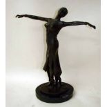 An Art Deco style bronze patinated figural model of a female dancer, standing on tip toes arms